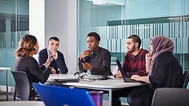 Students in a group around a table
