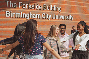 Students greeting eachother and happy outside university building